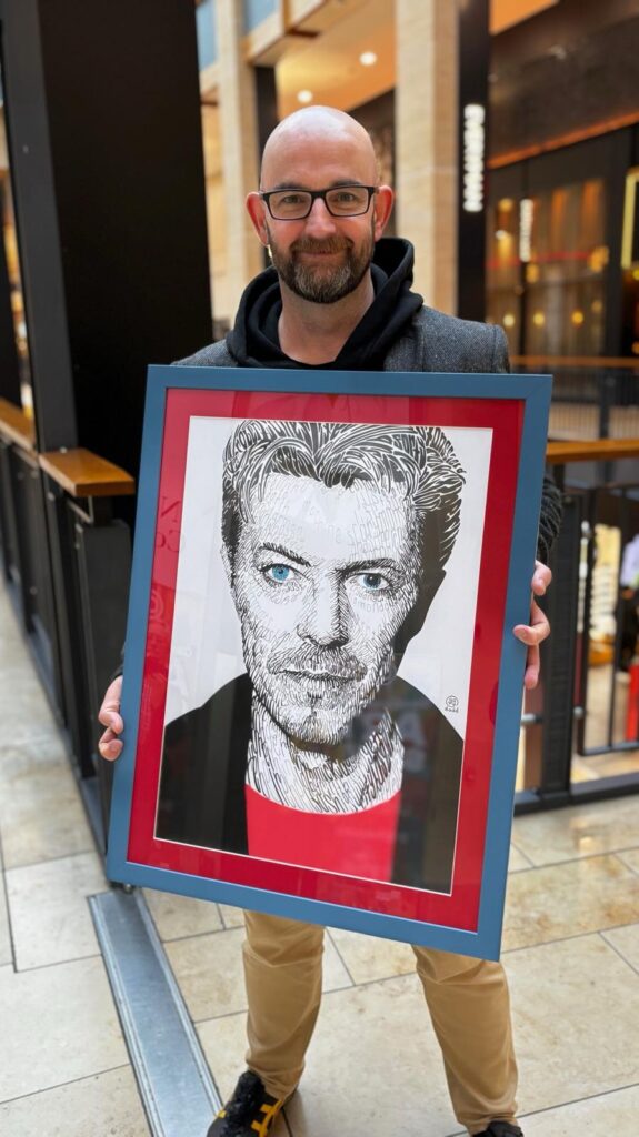 A portrait of David Bowie, that is also a biography. The artwork was meticulously created by UK artist Gary Dadd. All of Bowie's face and features are created by writing out key facts and information about the great man himself.